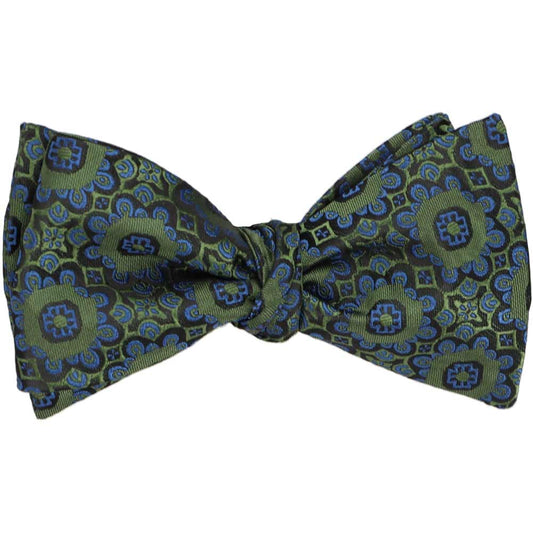 An avocado green self-tie bow tie, tied, in an abstract floral pattern